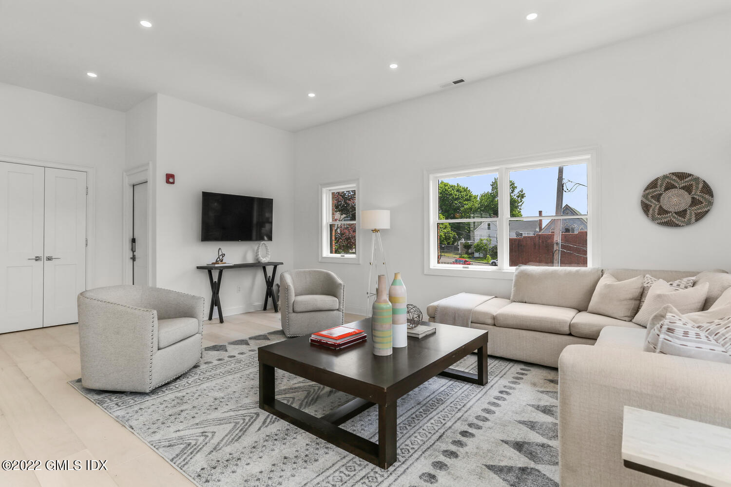 111 Mill Street, Unit PH Greenwich, CT 06830 - Photo 4 of 21 a living room with furniture a rug and a flat screen tv