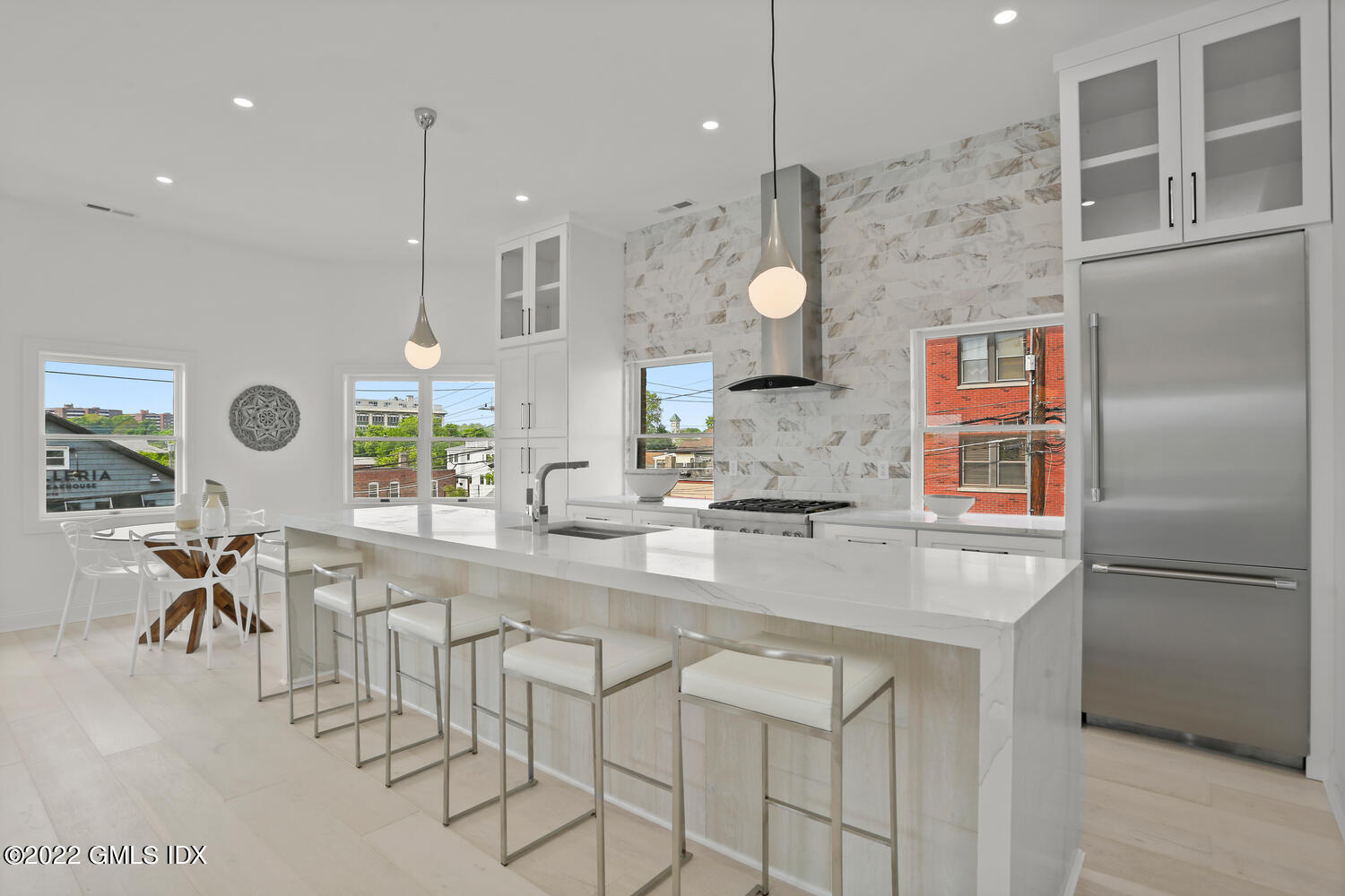 111 Mill Street, Unit PH Greenwich, CT 06830 - Photo 6 of 21 a kitchen with stainless steel appliances granite countertop a stove a sink and a refrigerator