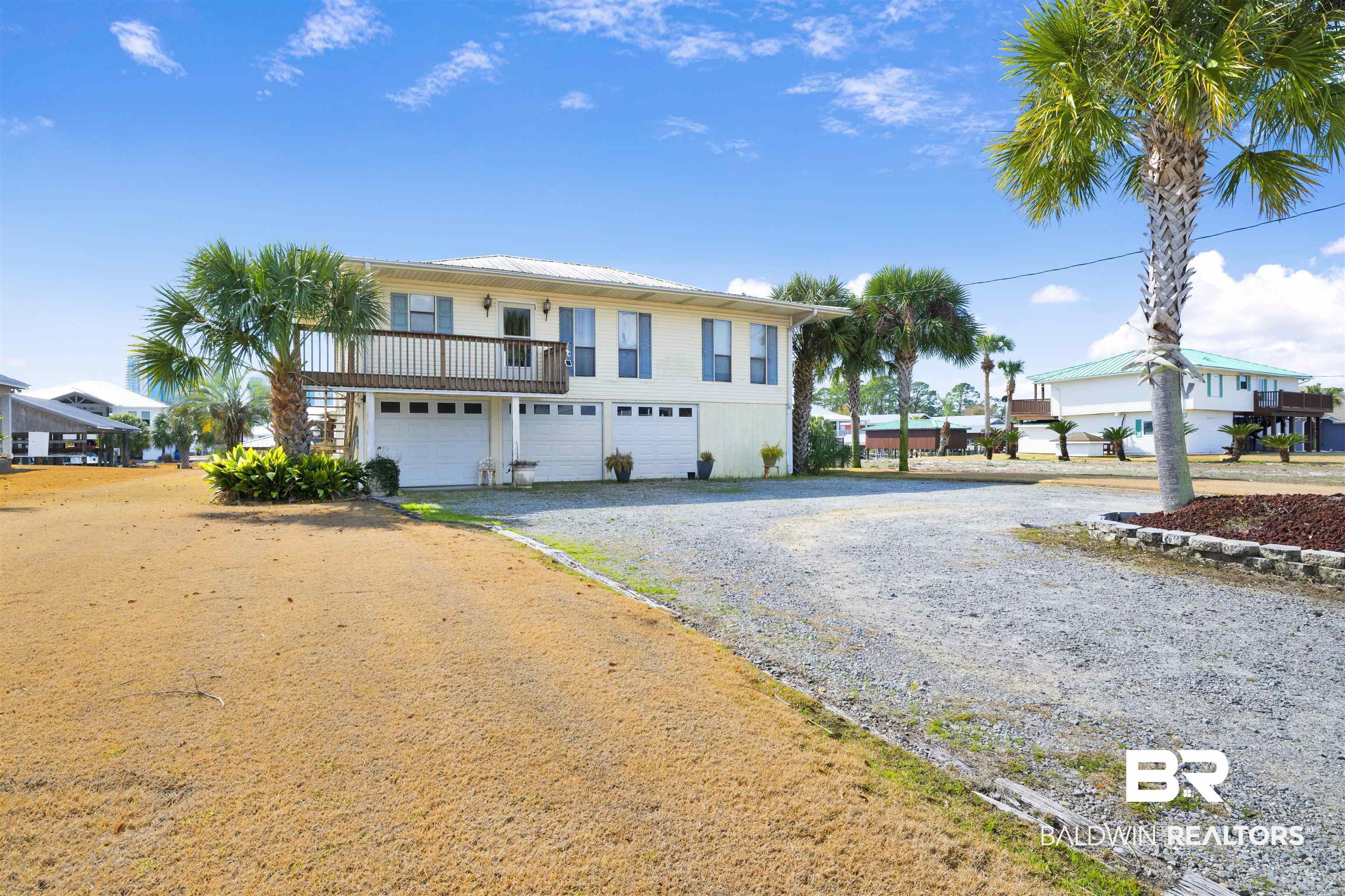 26222 Marina Road Orange Beach, AL 36561 - Photo 11 of 38 View of front of home with driveway, an attached garage, and a balcony
