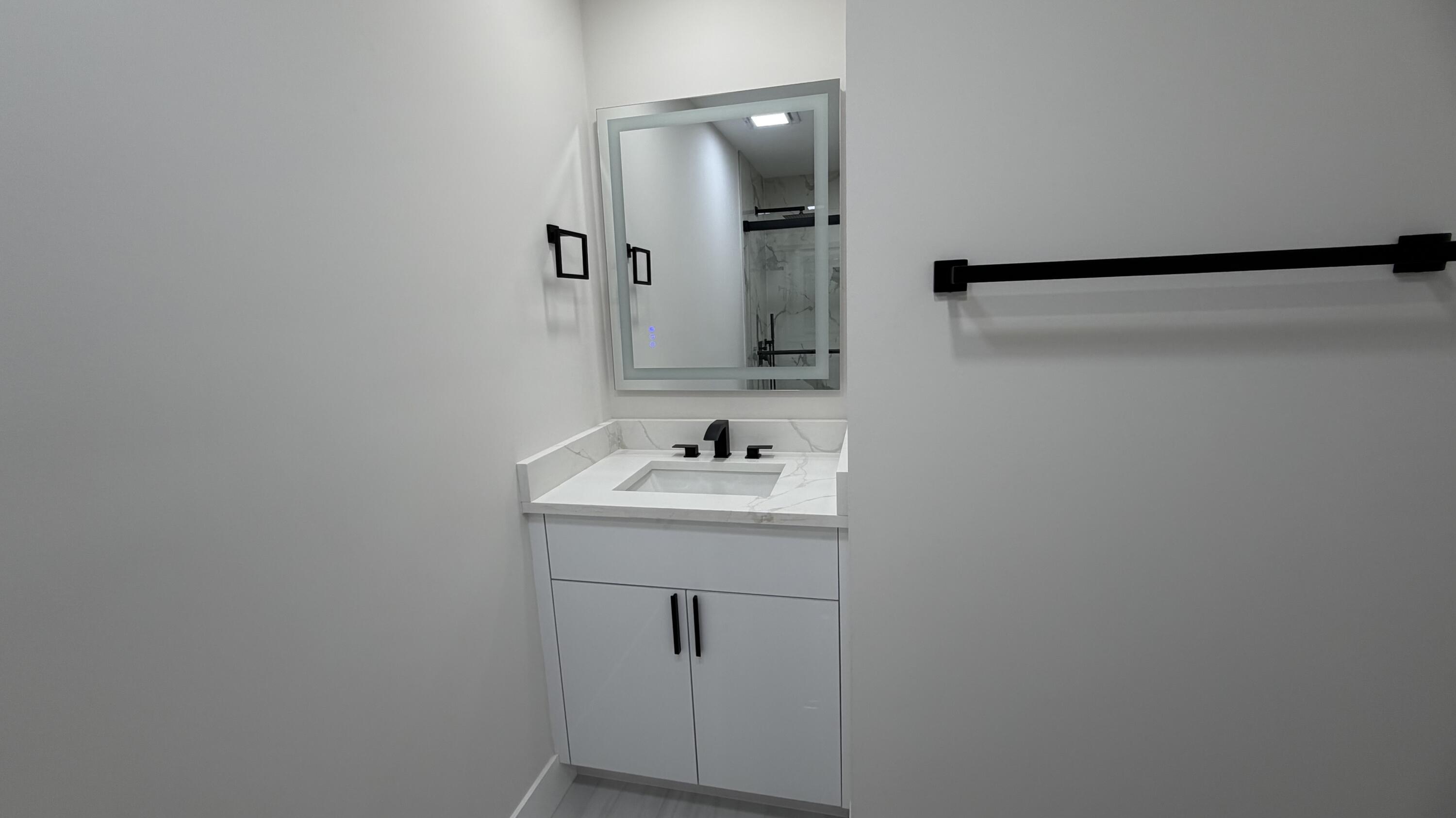 2521 Northeast 45th Street Lighthouse Point, FL 33064 - Photo 17 of 25 a bathroom with a sink and mirror