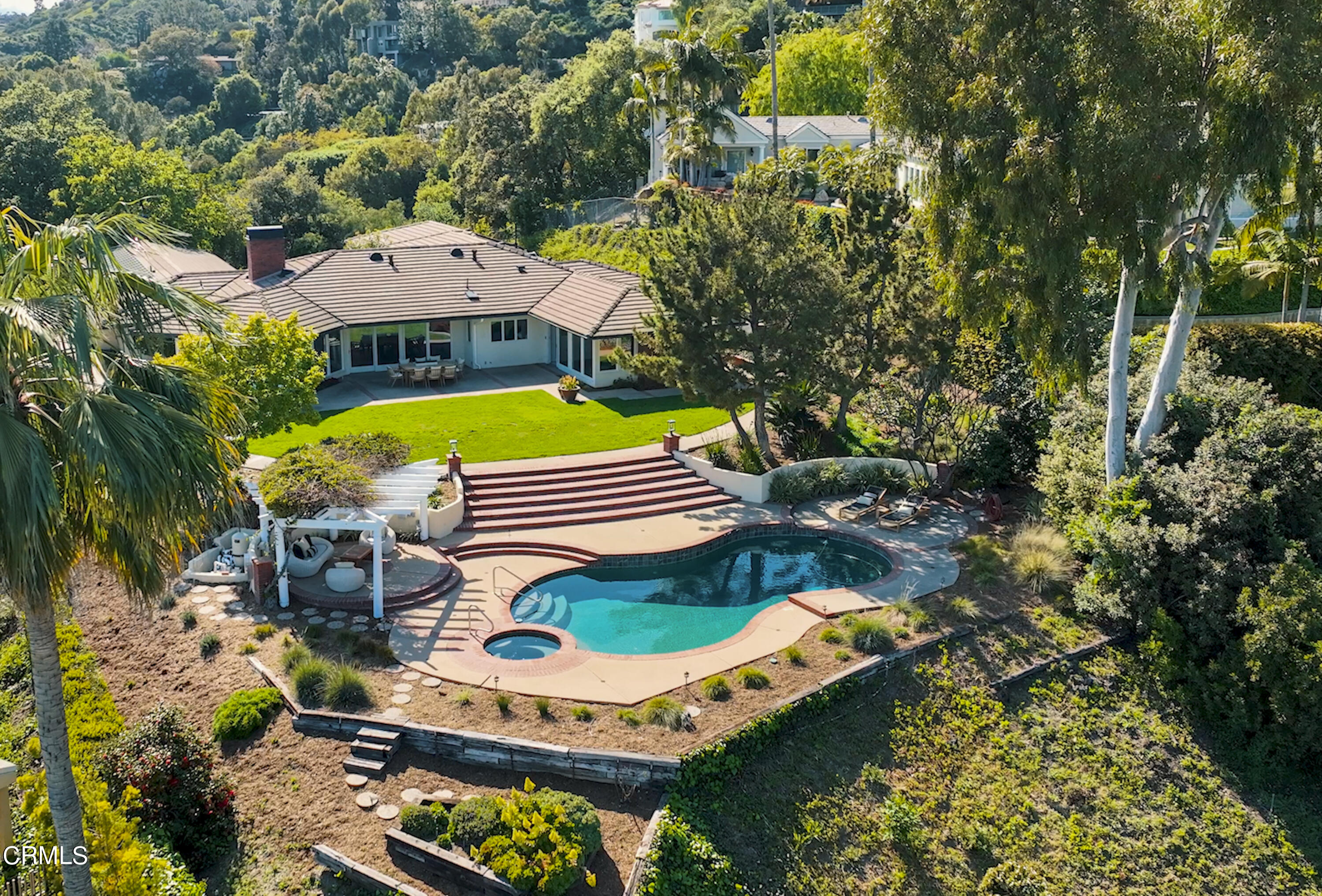 an aerial view of a house with a yard