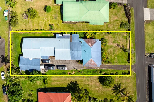 an aerial view of a house with a swimming pool