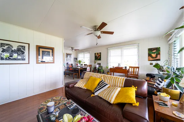 a living room with furniture fireplace and a window