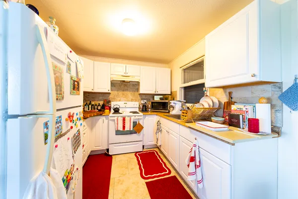 a kitchen with stainless steel appliances granite countertop a sink and cabinets