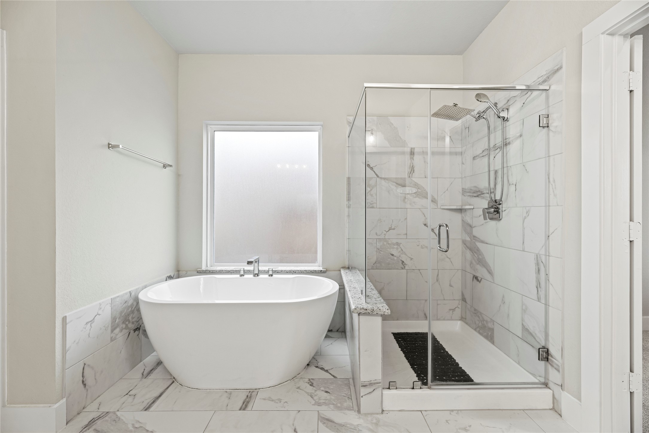 1600 Del Sol Rdg Lane Katy, TX 77493 - Photo 11 of 28 The freestanding soaking tub serves as a striking focal point, complemented by a spacious walk-in shower with a frameless glass enclosure.