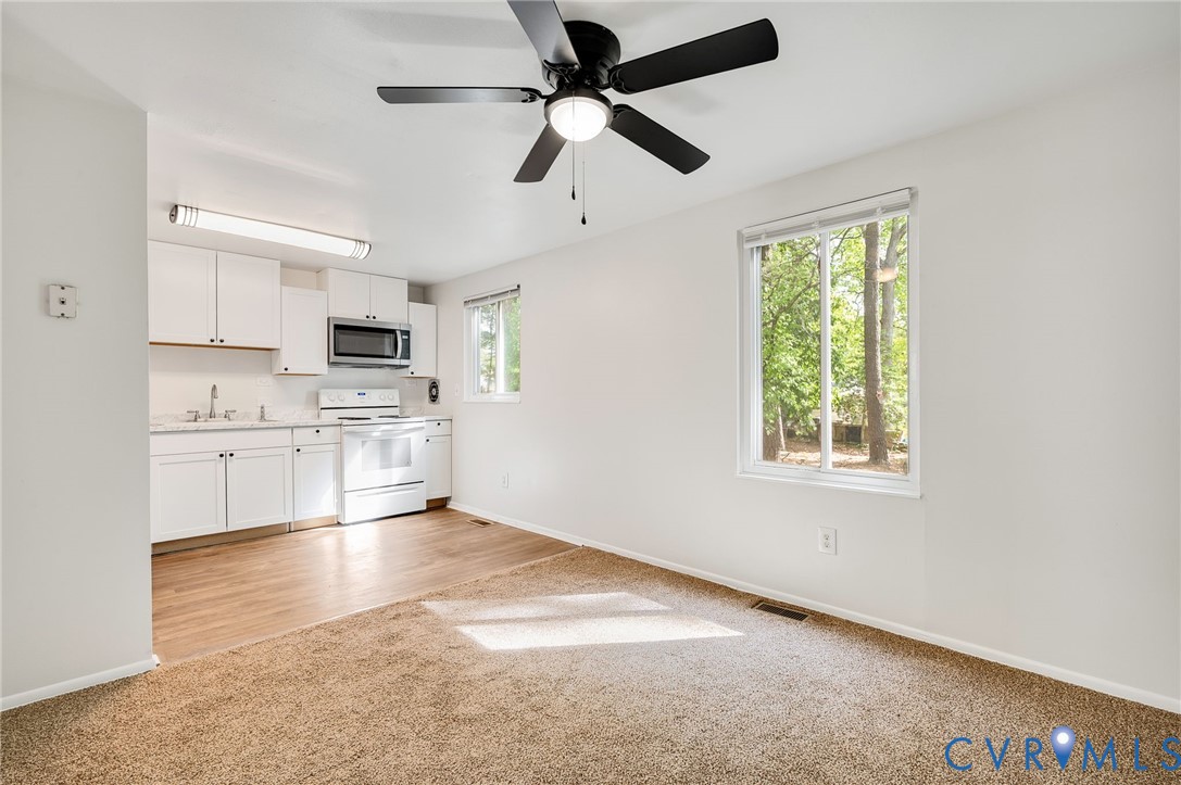 6513 Philbrook Road Richmond, VA 23234 - Photo 11 of 26 This bright living area features a kitchen with wh