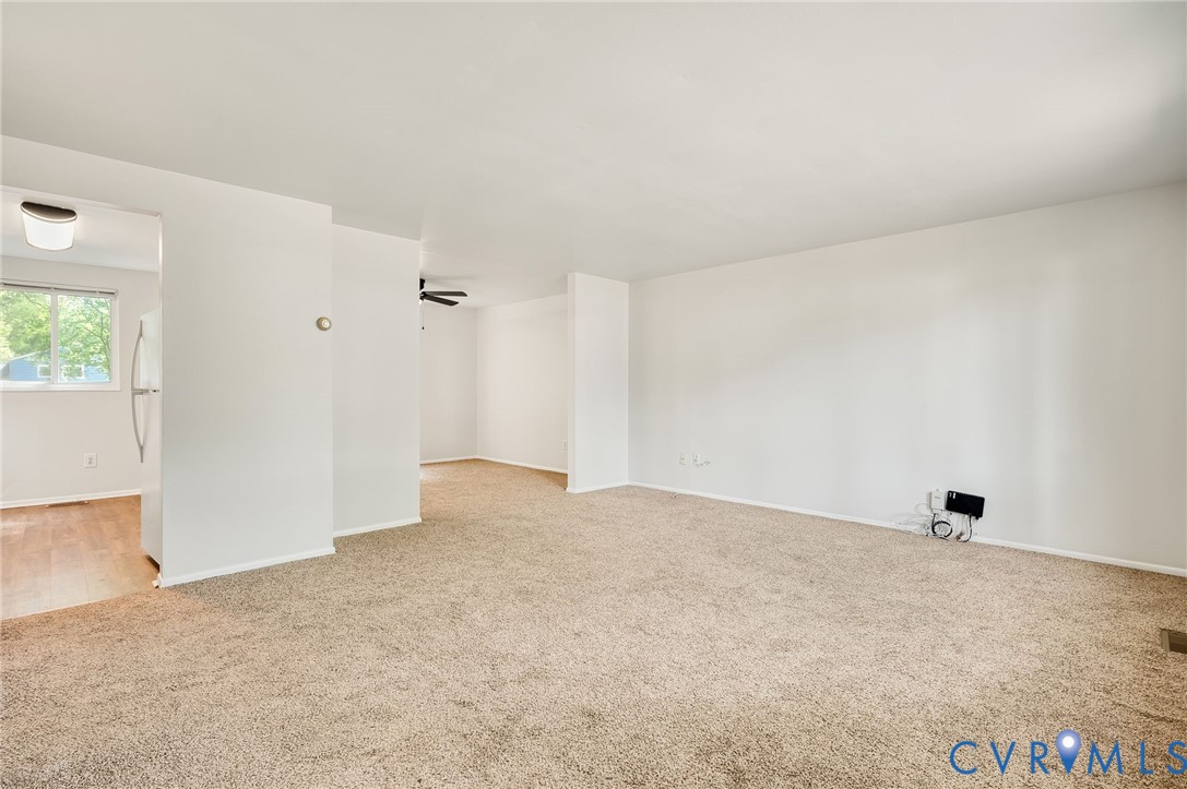 6513 Philbrook Road Richmond, VA 23234 - Photo 3 of 26 Spacious living area with neutral carpeting and wh