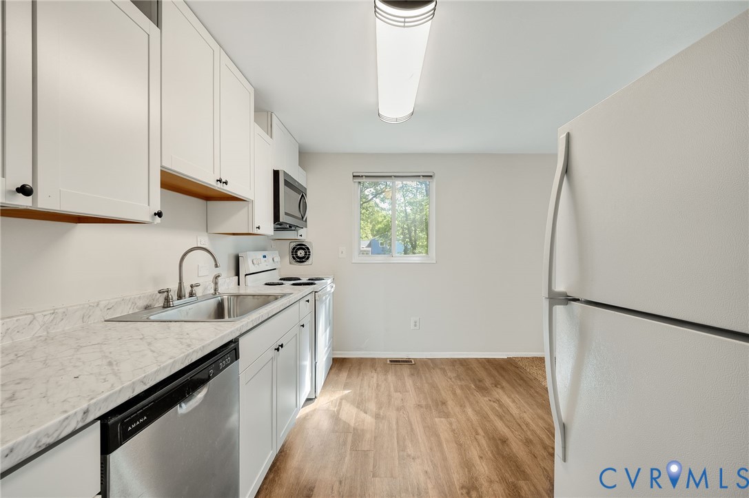 6513 Philbrook Road Richmond, VA 23234 - Photo 7 of 26 The kitchen features white cabinetry, a stainless