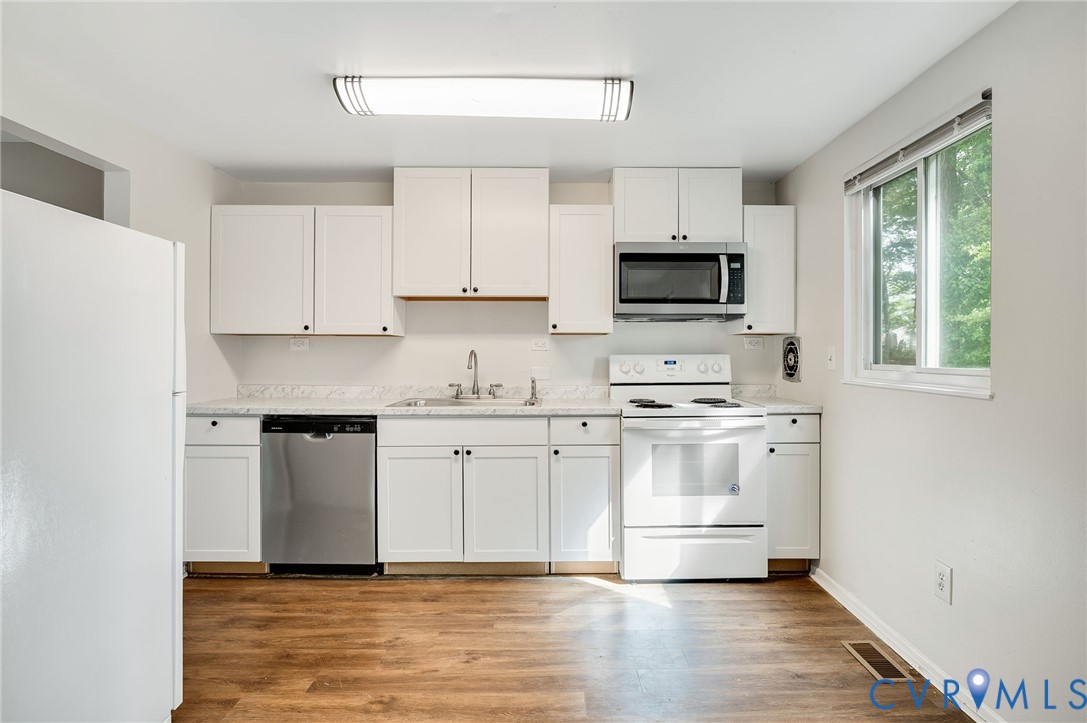 6513 Philbrook Road Richmond, VA 23234 - Photo 9 of 26 The kitchen features white cabinetry, a stainless