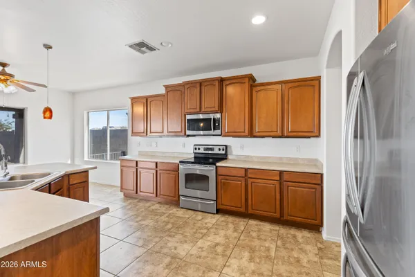 a large kitchen with stainless steel appliances granite countertop a stove and a sink