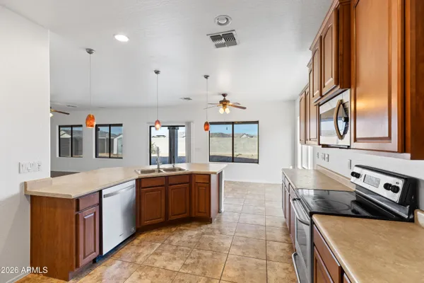 a living room with kitchen island furniture and a chandelier
