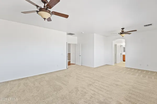 a spacious bathroom with a tub sink and mirror