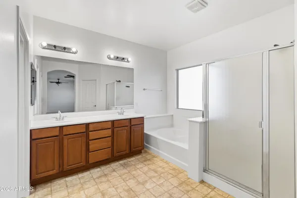 a bathroom with a double vanity sink and mirror