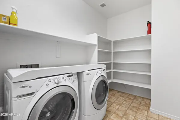 a view of a dry yard with wooden fence
