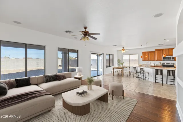 a living room with furniture a wooden floor and a large window