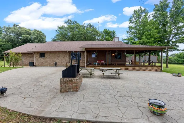 a view of a dining room with furniture large windows and wooden floor
