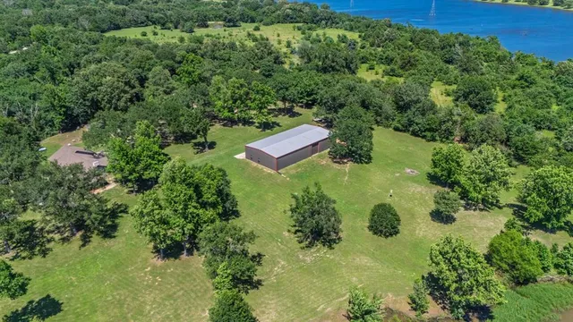 an aerial view of a house with a yard