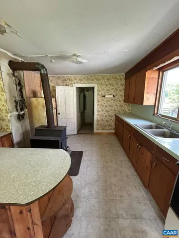 en empty room with windows and fireplace