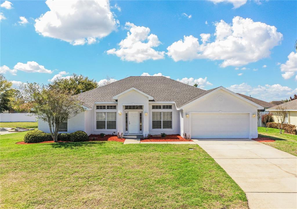 233 Towhee Road Winter Haven, FL 33881 - Photo 1 of 87 a front view of a house with garden