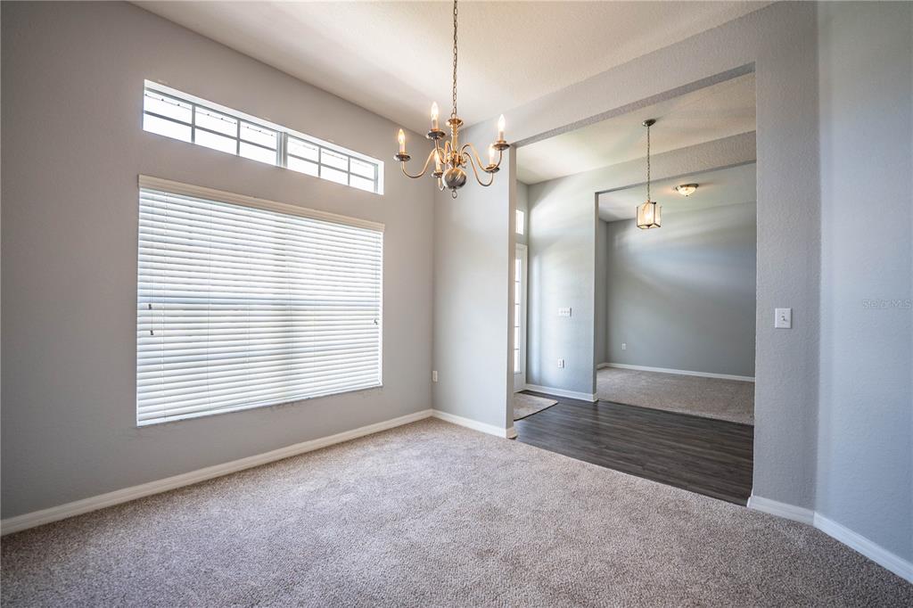 233 Towhee Road Winter Haven, FL 33881 - Photo 31 of 87 a view of an empty room with a window and chandelier