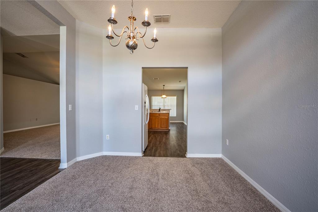233 Towhee Road Winter Haven, FL 33881 - Photo 34 of 87 a view of a hallway with wooden floor and a chandelier