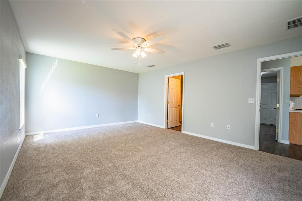 233 Towhee Road Winter Haven, FL 33881 - Photo 41 of 87 a view of an empty room with a ceiling fan and a window