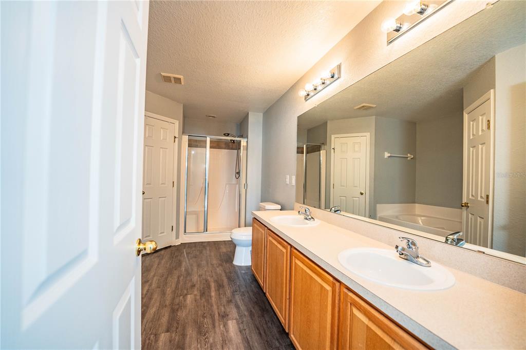 233 Towhee Road Winter Haven, FL 33881 - Photo 44 of 87 a bathroom with a double vanity sink and mirror with shower