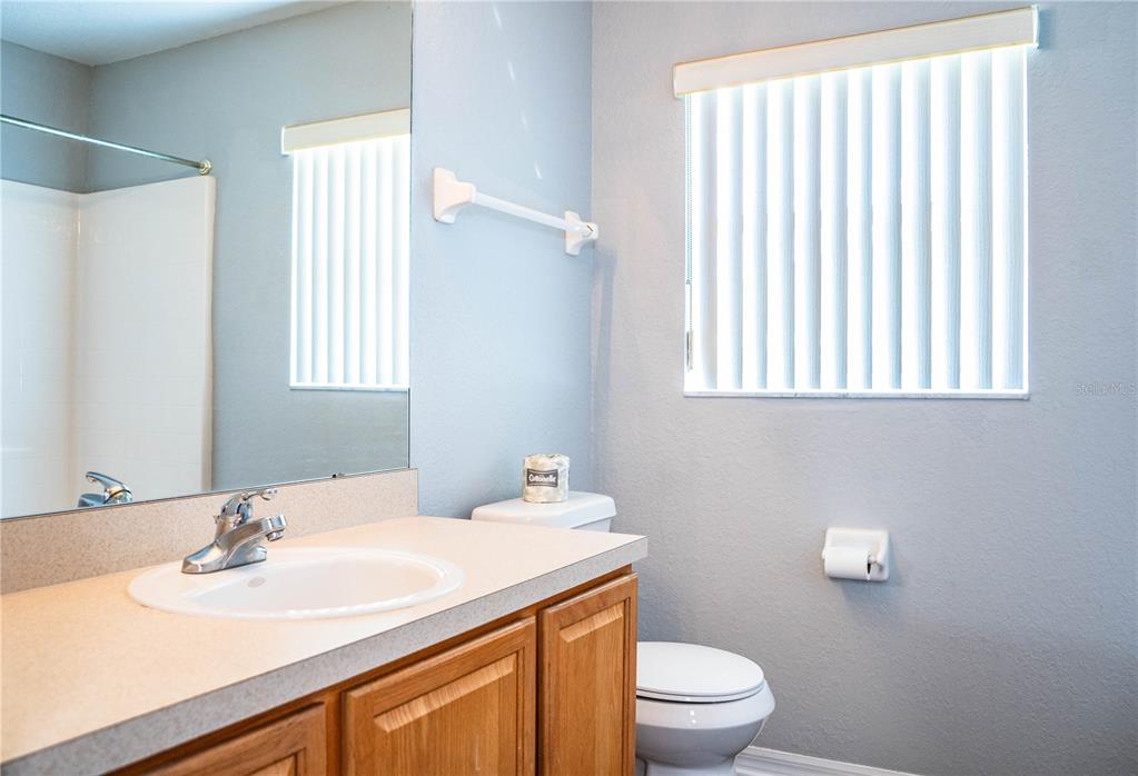 233 Towhee Road Winter Haven, FL 33881 - Photo 57 of 87 a bathroom with a sink a toilet and a window