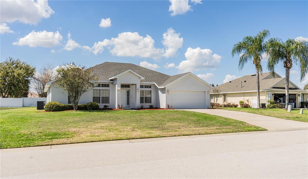 233 Towhee Road Winter Haven, FL 33881 - Photo 7 of 87 a front view of a house with a garden and trees