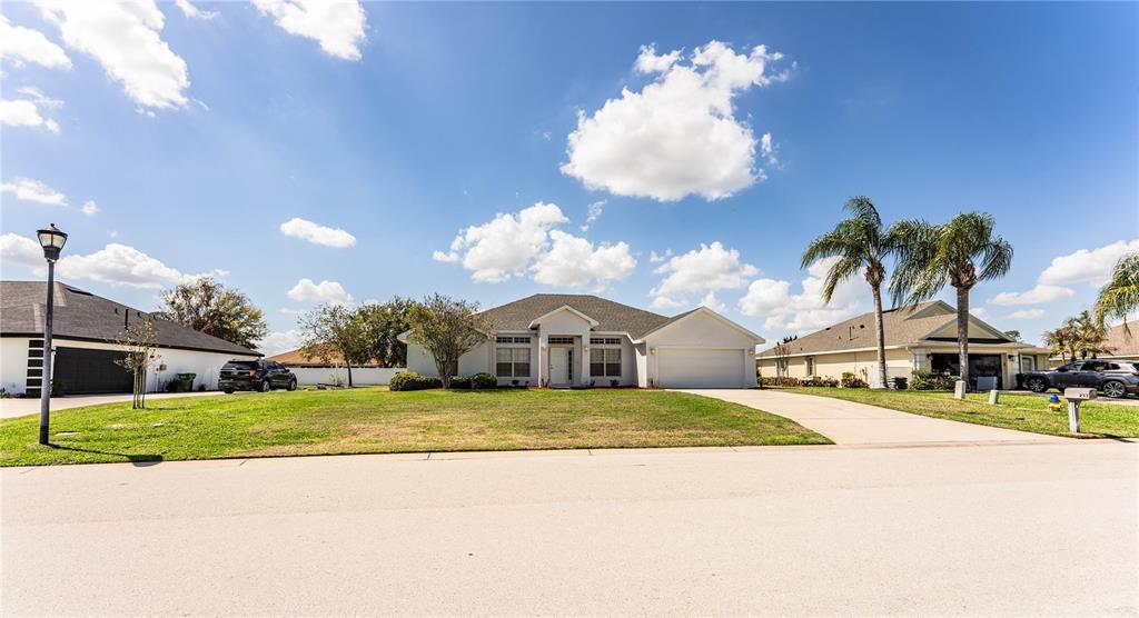 233 Towhee Road Winter Haven, FL 33881 - Photo 72 of 87 a view of a house with a yard and porch