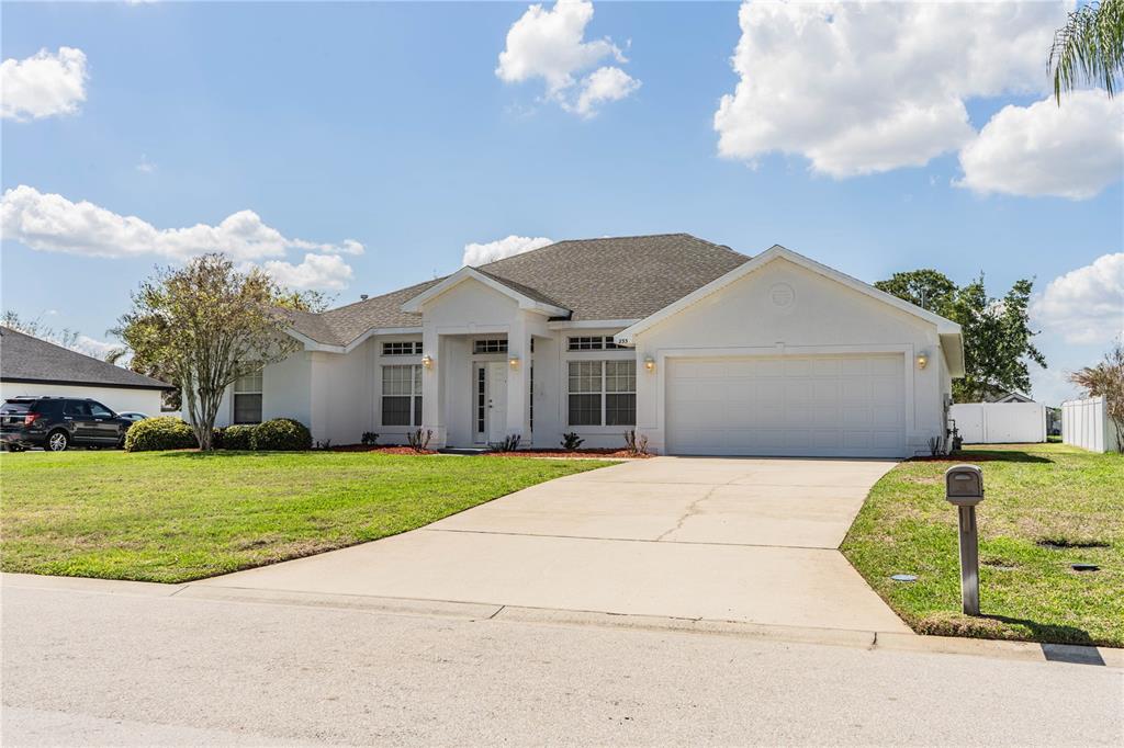 233 Towhee Road Winter Haven, FL 33881 - Photo 73 of 87 a front view of a house with a yard and garage