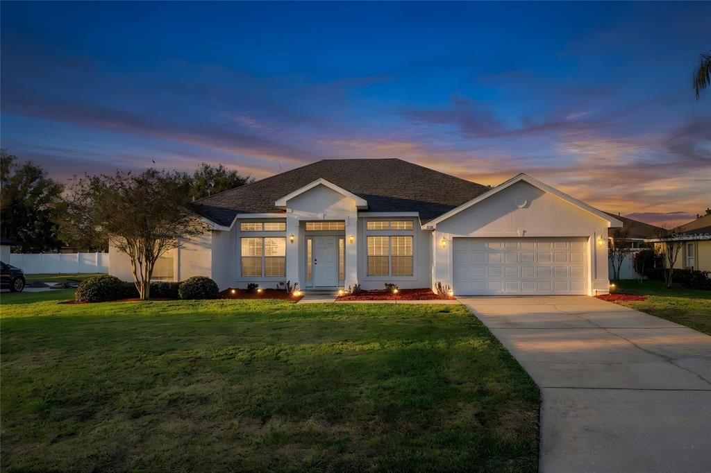 233 Towhee Road Winter Haven, FL 33881 - Photo 8 of 87 a front view of a house with a yard and garage