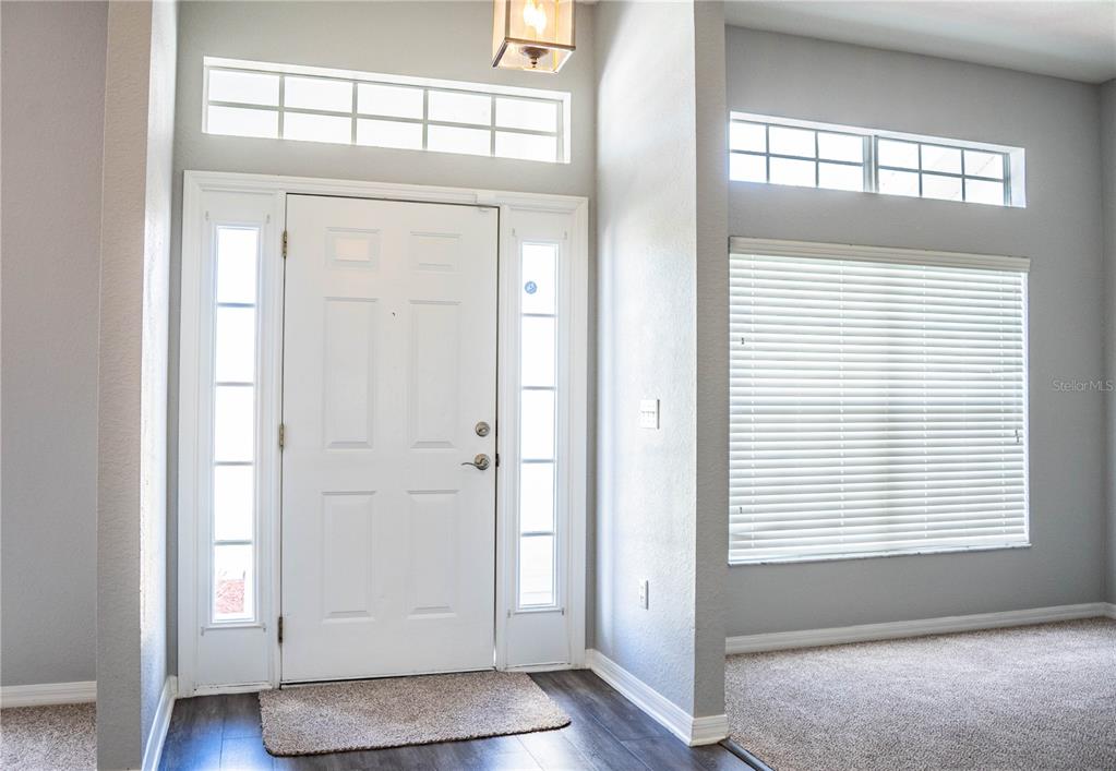 233 Towhee Road Winter Haven, FL 33881 - Photo 9 of 87 an empty room with wooden floor and windows