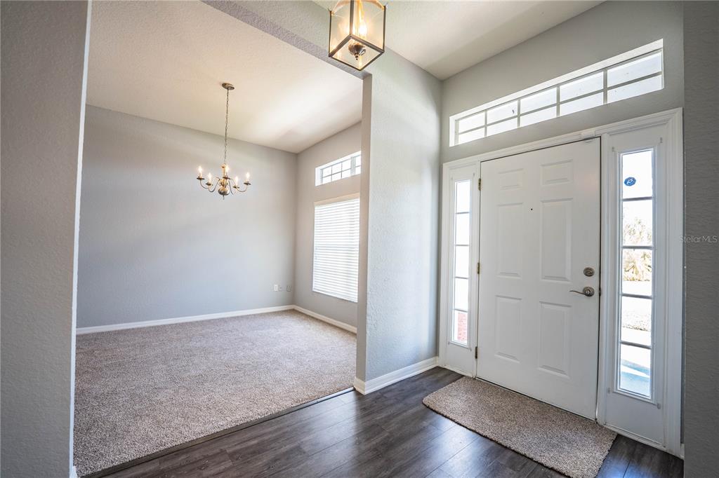 233 Towhee Road Winter Haven, FL 33881 - Photo 10 of 87 a view of an empty room with wooden floor and a window