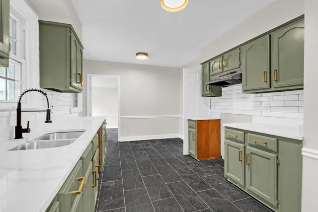 a bathroom with a sink a mirror and a window