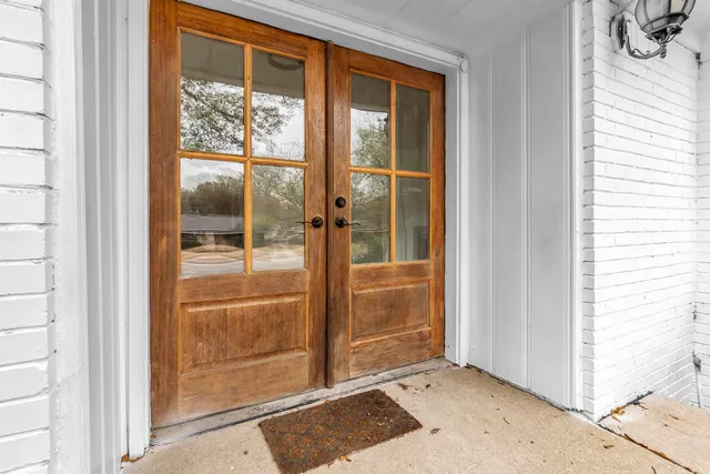 front view of a house with a large tree