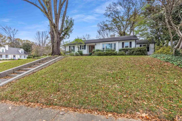 a front view of a house with a garden