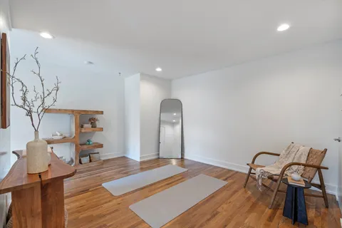 a bedroom with furniture and wooden floor