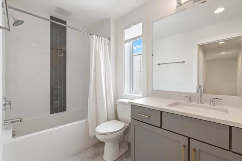 a bathroom with a sink toilet vanity and shower