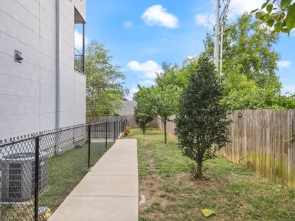a view of a pathway with a wrought fence