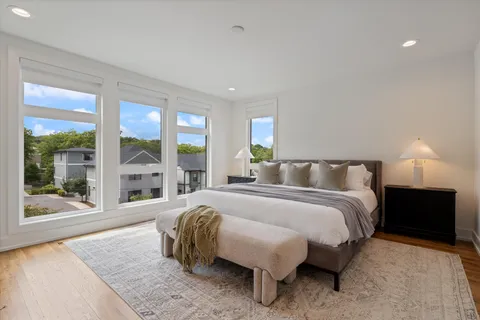 a spacious bedroom with a bed and large window