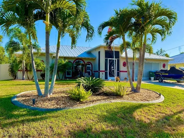 a front view of a house with garden and swimming pool