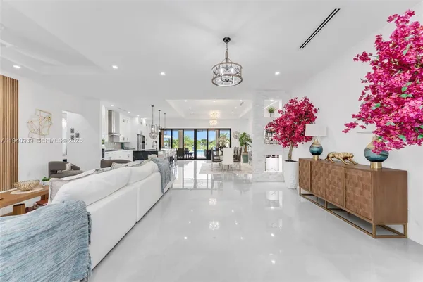 a living room with furniture and flowers