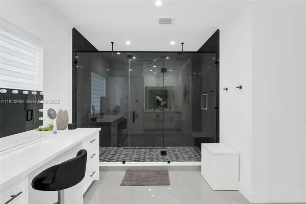 a spacious bathroom with a granite countertop sink mirror and bathtub