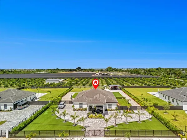 an aerial view of a house with a swimming pool