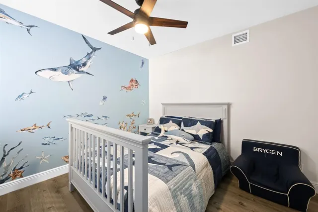 a bedroom with a bed and a chandelier