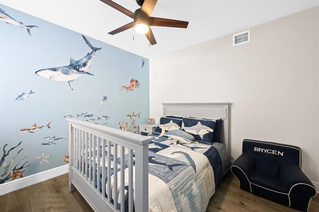 5298 Buckhead Circle, Unit 1040 Boca Raton, FL 33431 - Photo 14 of 25 a bedroom with a bed and a chandelier