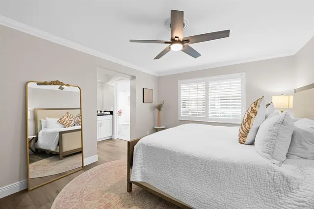 a bedroom with a bed and a mirror