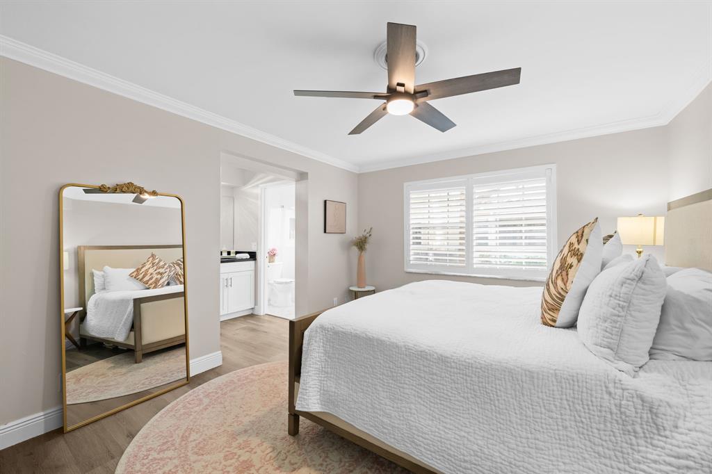 5298 Buckhead Circle, Unit 1040 Boca Raton, FL 33431 - Photo 17 of 25 a bedroom with a bed and a mirror