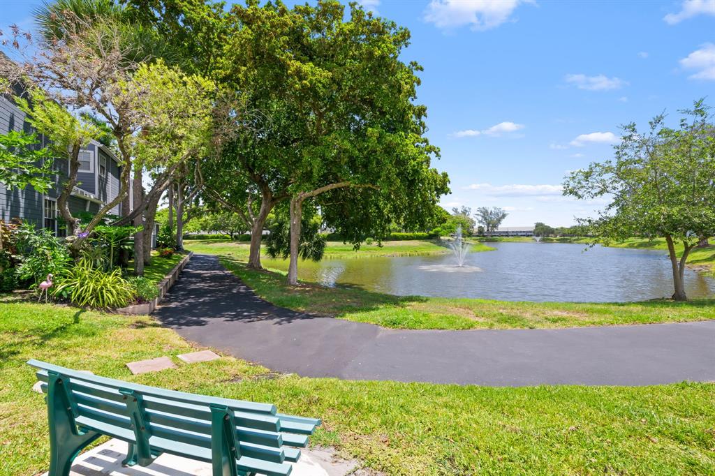 5298 Buckhead Circle, Unit 1040 Boca Raton, FL 33431 - Photo 25 of 25 a view of a yard with plants and a bench